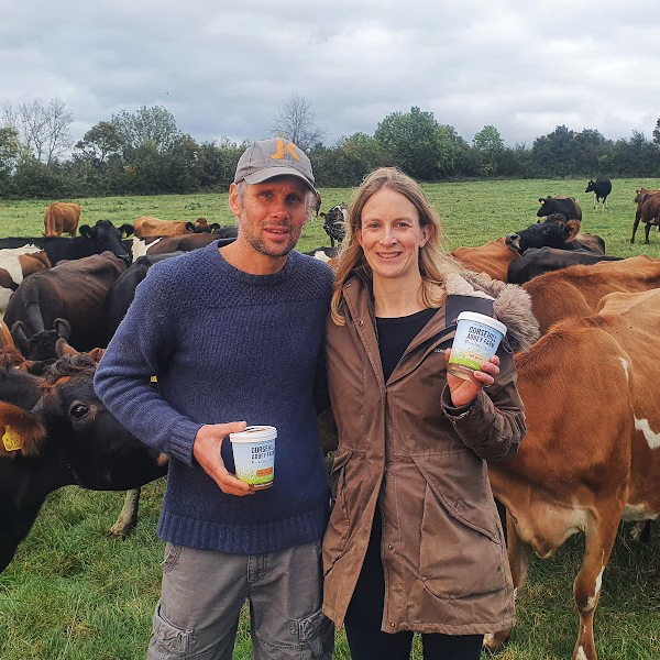 Nick and Jenny Shaylor with their cows in the background